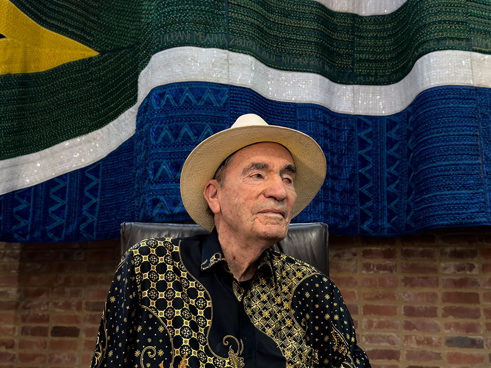 Albie in ConCourt main court chamber with beaded flag  in background. Multiple versions and hi-res available.